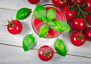 Fresh tomato juice as a source of vitamins. Wooden background