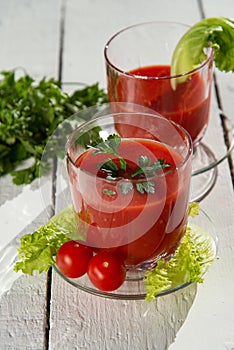 Fresh tomato juice with tomatoes and greens.