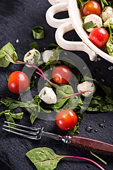 Fresh tomato and mozzarella salad on black slate