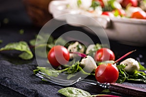 Fresh tomato and mozzarella salad on black slate