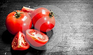 Fresh tomatoes . On black chalkboard.