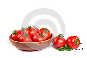 Fresh tomatoes in a bowl with basil isolated
