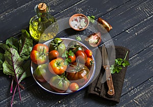 Fresh tomatoes, garden herbs and olive oil