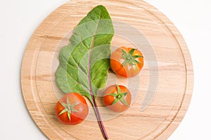 Fresh Tomatoes On Wooden Plate