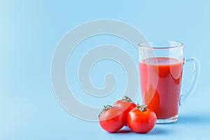 Fresh tomatoes and a glass full of tomato juice