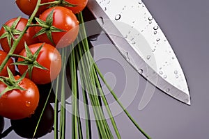 Fresh tomatoes and knife