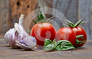 Fresh tomatoes with leaf basil at old