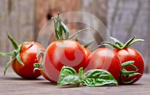 Fresh tomatoes with leaf basil at old