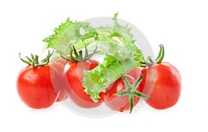 Fresh tomatoes and lettuce leaf on white