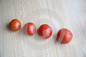 Fresh tomatoes on the table with wood texture