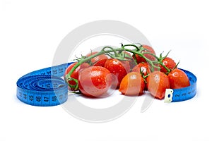Fresh tomatoes on vine health concept with tape measure