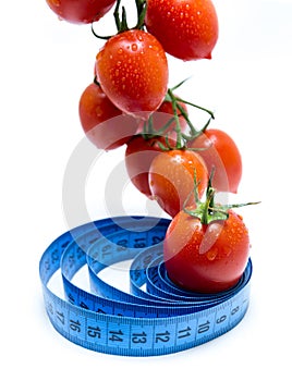 Fresh tomatoes on vine healthy diet concept with tape measure