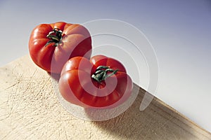 Fresh tomatoes on a wooden board photo