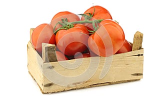 Fresh tomatoes in a wooden crate