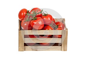 Fresh tomatoes in a wooden crate isolate on a white