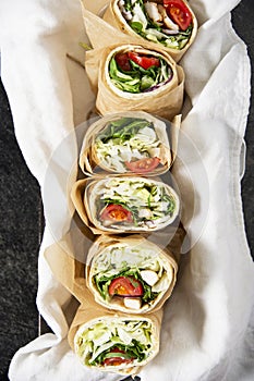 Fresh tortilla wraps with vegetables and chicken.