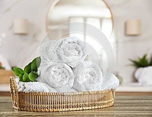 Fresh towels on table in bathroom