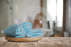 Fresh towels on table in bathroom. Space for text