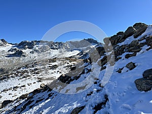 Fresh tracks on the season\'s first early autumn snow above the road pass Fluela (Fluelapass)