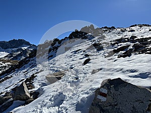 Fresh tracks on the season\'s first early autumn snow above the road pass Fluela (Fluelapass)