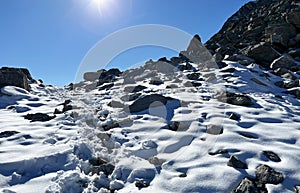 Fresh tracks on the season\'s first early autumn snow above the road pass Fluela (Fluelapass)