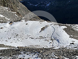 Fresh tracks on the season\'s first early autumn snow above the road pass Fluela (Fluelapass)