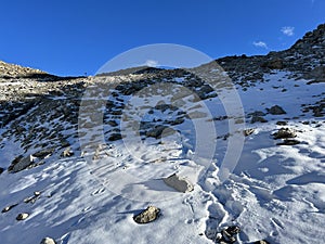 Fresh tracks on the season\'s first early autumn snow above the road pass Fluela (Fluelapass)