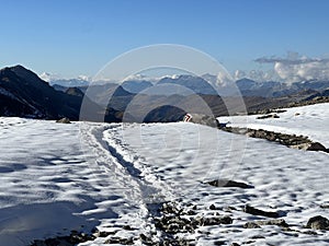 Fresh tracks on the season\'s first early autumn snow above the road pass Fluela (Fluelapass)
