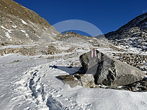 Fresh tracks on the season\'s first early autumn snow above the road pass Fluela (Fluelapass)