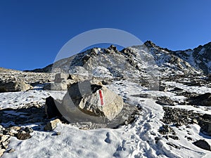 Fresh tracks on the season\'s first early autumn snow above the road pass Fluela (Fluelapass)