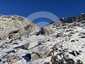 Fresh tracks on the season\'s first early autumn snow above the road pass Fluela (Fluelapass)