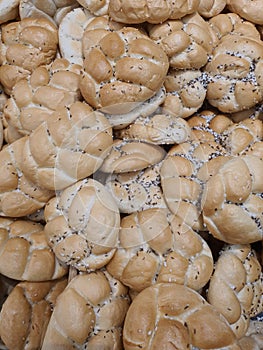 Fresh traditional Czech houska bun with salt and cumin seeds in bakery