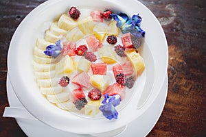 Fresh tropical fruit dressing on   yogurt milk morning fod meal