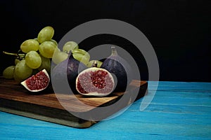 Fresh tropical fruit with ripe figs and grapes