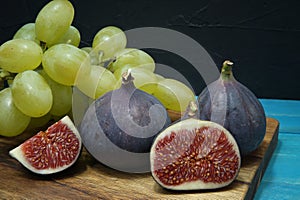 Fresh tropical fruit with ripe figs and grapes