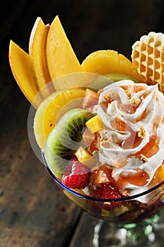 Fresh tropical fruit salad with whipped cream