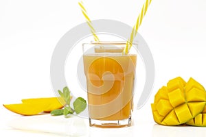 Fresh tropical fruit smoothie mango juice and fresh mango on a white background.