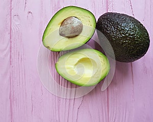 Fresh tropical green avocado ingredient nutritious food on a pink wooden antioxidant