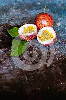 Fresh Tropical Passion Fruits on dark grunge background top view flat lay with copy space for background or wallpaper. Ripe passio