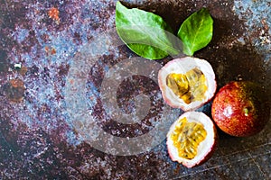 Fresh Tropical Passion Fruits on dark grunge background top view flat lay with copy space for background or wallpaper. Ripe passio