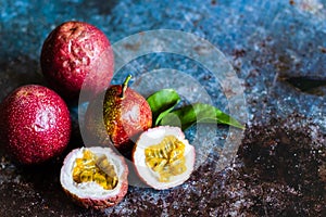 Fresh Tropical Passion Fruits on dark grunge background top view flat lay with copy space for background or wallpaper. Ripe passio