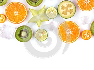 Fresh tropical slices of fruits isolated on white background. Juicy oranges, kiwis, carambolas and ice.