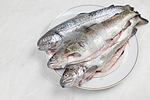 Fresh trout on the plate ready for preparing
