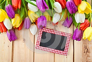 Fresh tulips on wooden background