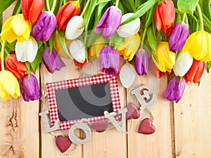 Fresh tulips on wooden background