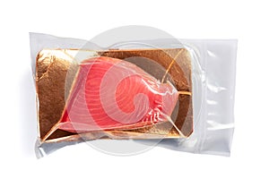 Fresh tuna fillet vacuum packed. Fish steak on a white background. Red fish textured steak isolated