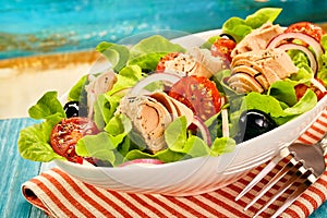 Fresh tuna salad with lettuce, olives and tomato