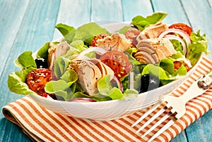 Fresh tuna salad with lettuce, olives and tomato