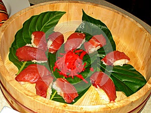 Fresh tuna slices arranged in a wooden bowl