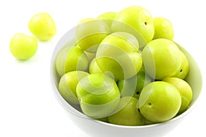 Fresh turkish can erik plum fruits in a small white bowl